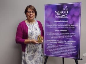 Elizabeth, WINGS Survivor Lifeline Coordinator, with the Purple Ribbon Award