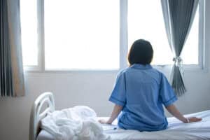 Patient in a hospital looking out of a window.