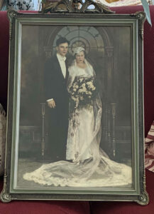 A picture of Anne in her wedding dress pictured next to her partner