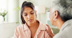 Counseling session, therapist and comfort sad patient with trauma, ptsd and chat for mental health advice