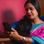 mouli-ghosh Woman holding mobile device